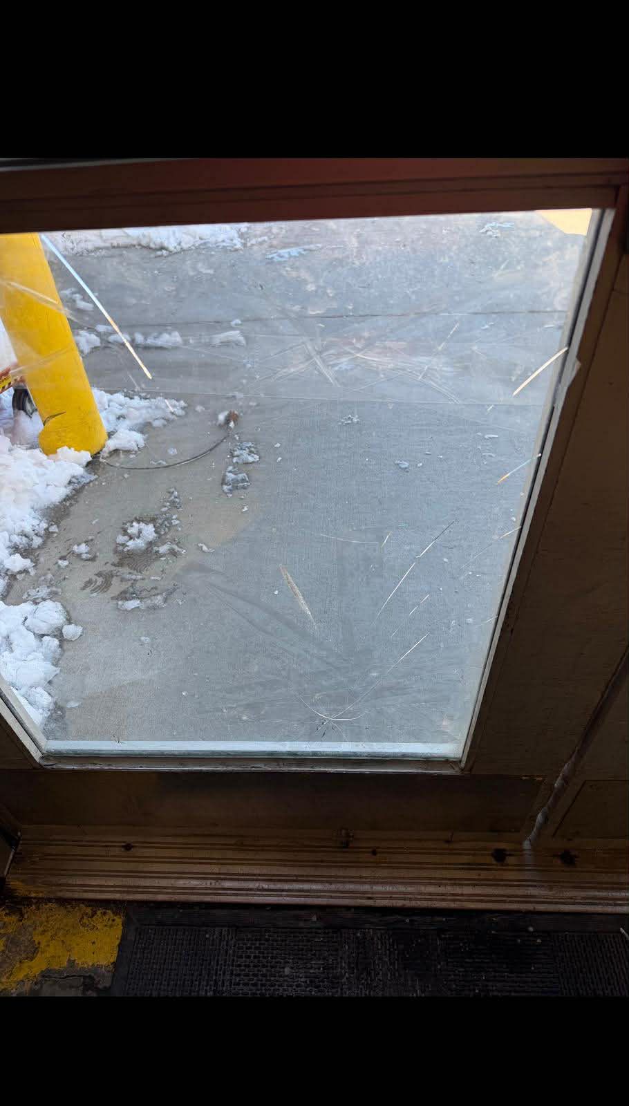 Door glass damage before repair.